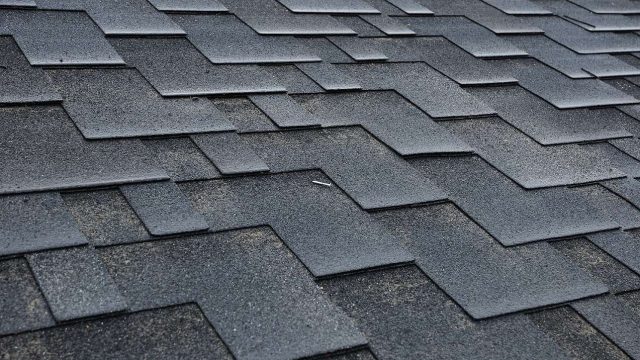 Close up view on Asphalt Roofing Shingles Background. Roof Shingles - Roofing.